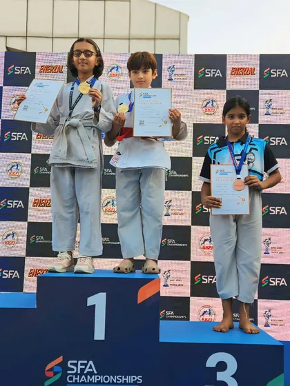 Young champions on the podium. We start training them early to build a strong foundation for competitive success.