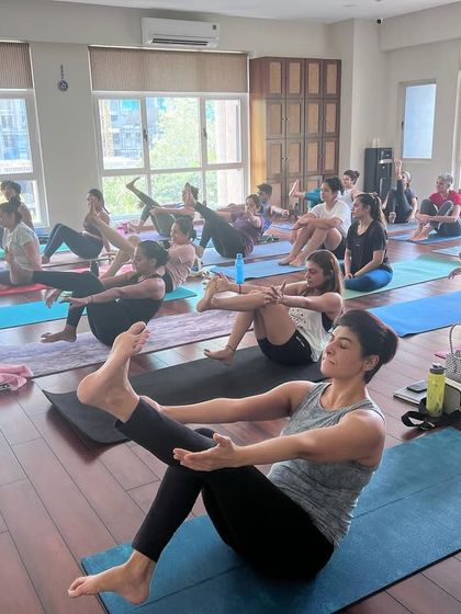 A student works on Navasana (Boat Pose) variations during a workshop with RCP. These sessions focus on building core strength, which is the foundation for more advanced asanas.