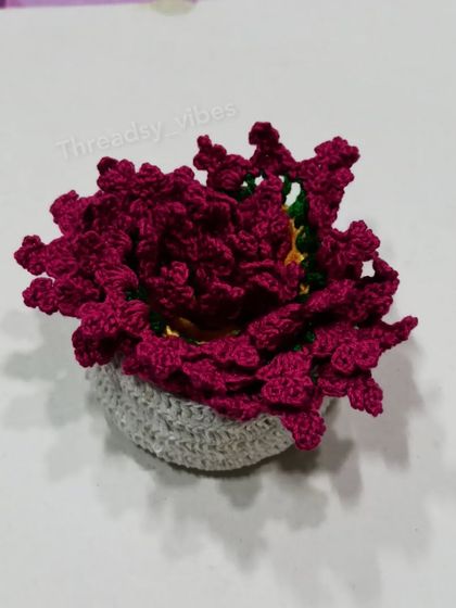 This is what my floral coasters look like when they are all stacked up inside their crocheted holder. It keeps them neat and looks like a little flowerpot itself.