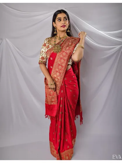 A full-length view of the model in a beautiful red saree, part of a professional collaboration.