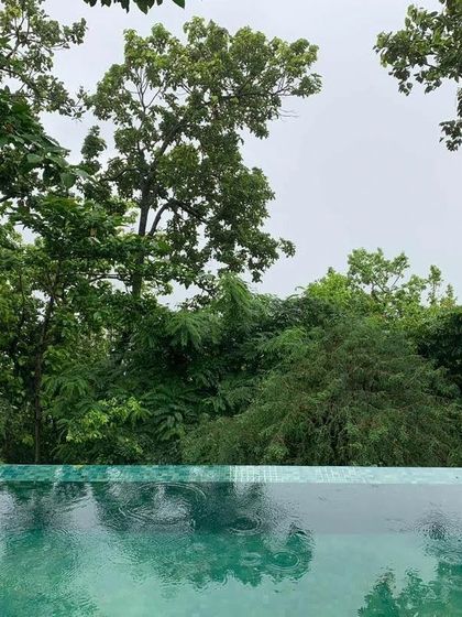 An infinity pool overlooking the lush green foothills of the Himalayas. Even in moments of relaxation, the connection to nature is ever-present. This is a space for quiet contemplation after a day of practice.