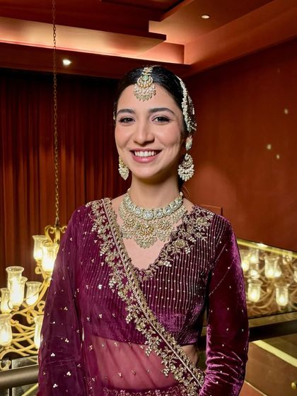 A full view of this bride's breathtaking wedding look. The deep color of her velvet outfit was balanced with a soft, radiant makeup application, creating a look of pure elegance.