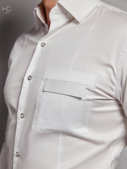A close-up of the flap pocket on the white shirt. It's a small detail that adds a lot of character to the garment.