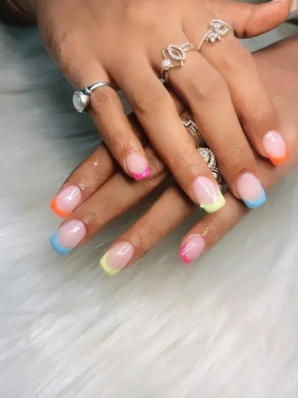 A multi-colored pastel French manicure, with each tip painted a different soft shade. This is a beautiful and creative way to wear multiple colors at once.