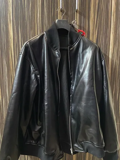 Beyond denim and cotton, I also create custom jackets like this black bomber. It features a sleek faux leather finish, zip front, and comfortable ribbed collar and cuffs, all made to your size.