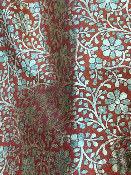 This rich, red brocade fabric with a silver floral pattern is a fantastic choice for a statement wedding jacket or a festive kurta.