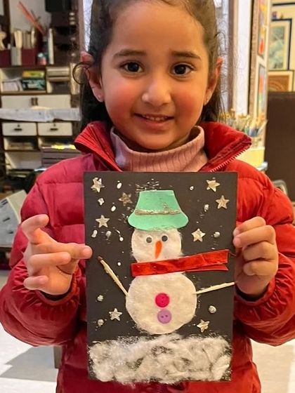 This festive snowman card, complete with a sparkly hat and button eyes, was made by one of our young students during our winter-themed art class.
