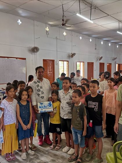 A group of young boys from the Gogamukh College workshop, excited to show the artwork they created. Their enthusiasm is contagious.