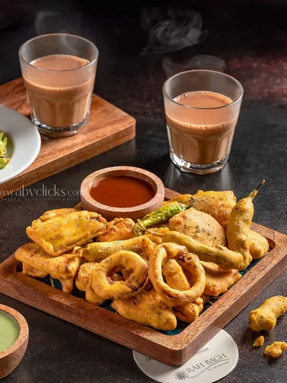A perfect rainy day snack of assorted pakoras with chai, shot for Hotel Rahbagh, Srinagar. The steam from the tea adds a cozy feel.