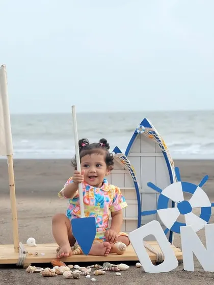 An adventurous first birthday shoot with a sailor theme right on the beach. The open sea, sand, and our custom boat props create a perfect setting for capturing your little explorer's special day.