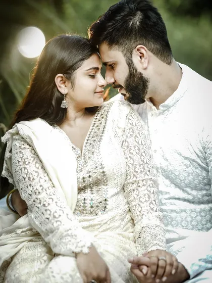 An intense and romantic close-up from a pre-wedding shoot. The focus is entirely on the couple's connection, with the natural background softly blurred.