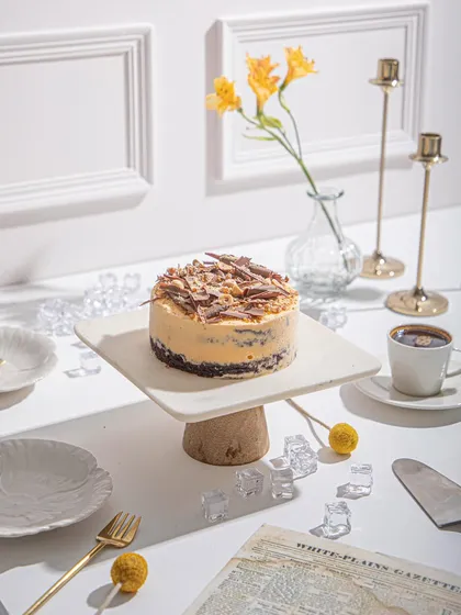 Our Mango and Chocolate Ice Cream Cake, ready to be served with coffee. It’s a versatile dessert that’s perfect for any time of day.