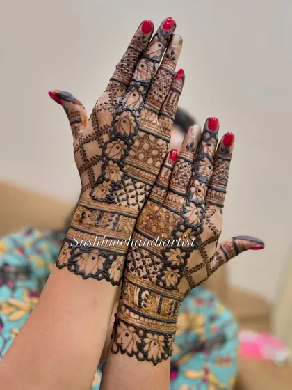 A different pose showing the beautiful jaali design. The pattern covers the back of the hand elegantly.