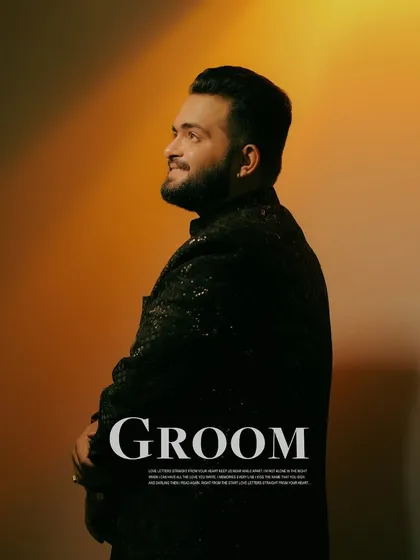 A stylish portrait of the groom against a warm, studio-lit background. We make sure the groom's portraits are just as impactful, capturing his personality and style.