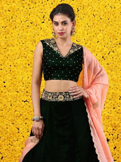 A close-up that captures the luxurious feel of the velvet and the intricate embroidery on the blouse and belt.