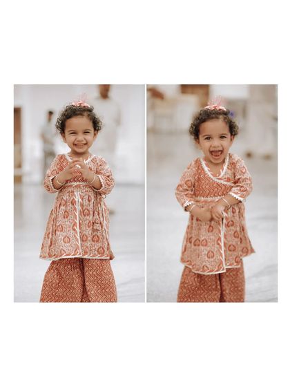An adorable portrait of a young guest in traditional attire, her happy smile stealing the show.