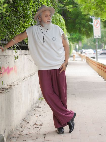 Another dynamic pose from the same street style shoot, showcasing the model's unique fashion sense and comfortable presence in front of the camera.