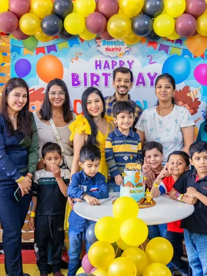 A group photo from Damian's 5th birthday party, showing all the kids excited about the unique construction-themed cake.