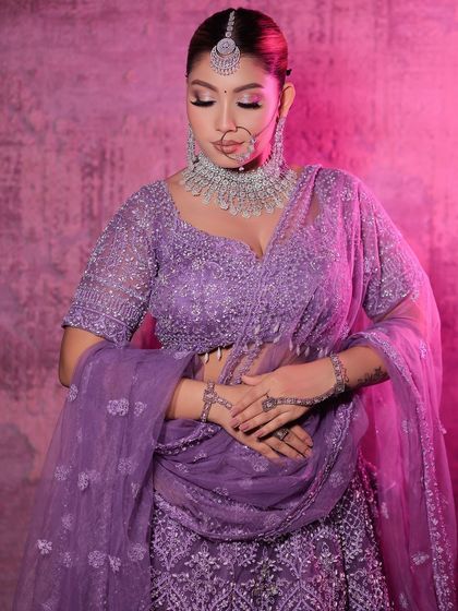 A modern bridal look featuring a lavender lehenga paired with a stunning diamond and silver jewellery set. This shows how you can rent contemporary jewellery for a unique look.