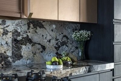 A close-up of the stunning black and white marble countertop in this luxurious kitchen. The natural patterns of the stone, paired with fresh fruit and flowers, highlight the beauty of the materials I love to work with.