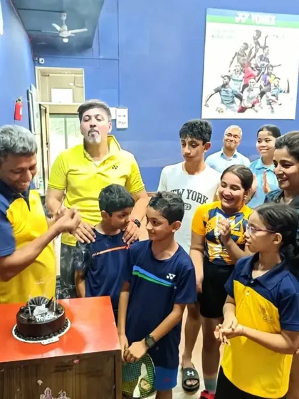 The whole group joins in to celebrate their coach's birthday.
