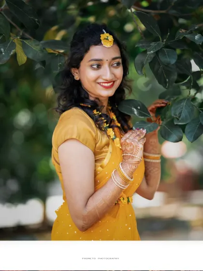 A beautiful, candid portrait of the bride amidst the greenery, her smile glowing with happiness.