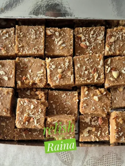 A silver box filled with almond-topped Gur Papdi. It makes for a lovely and simple gift.