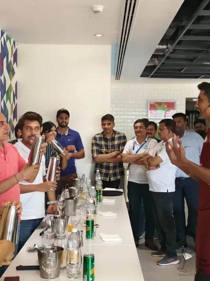 Guests at a corporate workshop trying their hand at shaking their own cocktails. It's a great team-building exercise that's both fun and rewarding.