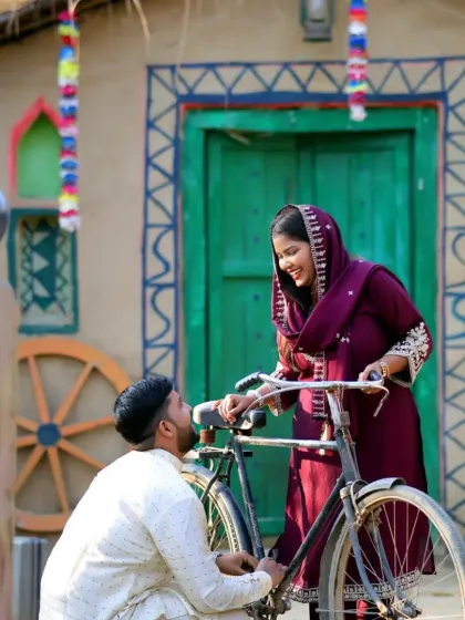 A classic romantic pose with a bicycle from the village-themed pre-wedding shoot. This setup is charming and timeless, telling a simple and sweet love story.