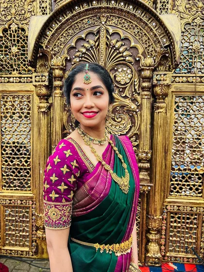 I believe in makeup that enhances your natural beauty, making you feel like the best version of yourself. This is a perfect example of a radiant muhurtham look for the groom's sister, focusing on glowing skin, a bright smile, and traditional South Indian jewelry.