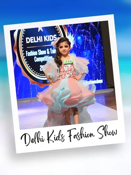 This intricate blue and pink gown with puffy sleeves is a true showstopper. The participant's confident pose highlights the beautiful design of the dress.