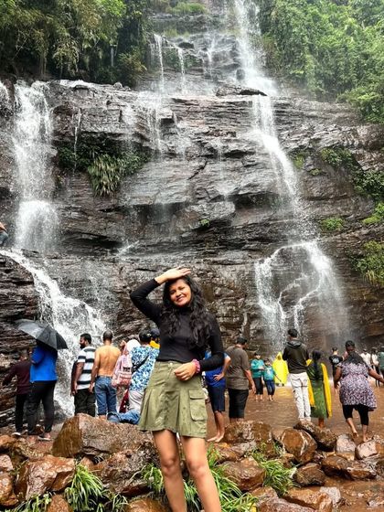 A trekker enjoying the view at Jhari Falls in Chikmagalur. Our leisure trips include jeep rides to get you to stunning spots like this.