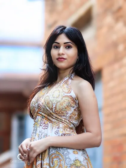 A beautiful portrait in a classic brick-lined alley. The setting adds a touch of rustic charm to her elegant look.