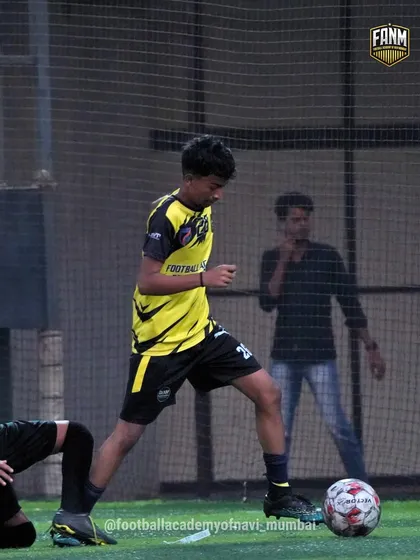 A player works on his dribbling technique during a practice session, focused on keeping the ball close.