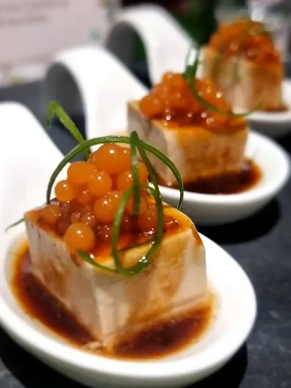 Silken Tofu with soy dressing and salmon roe. This is a delicate and refined canapé from our Asian menu, showcasing our use of high-quality ingredients.