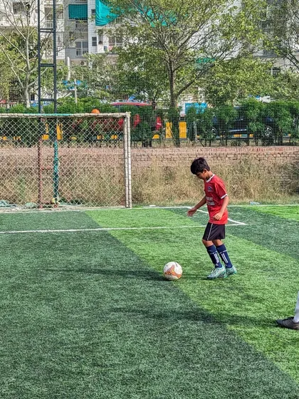A player sets up for a shot on goal during the friendly match, aiming for the back of the net.