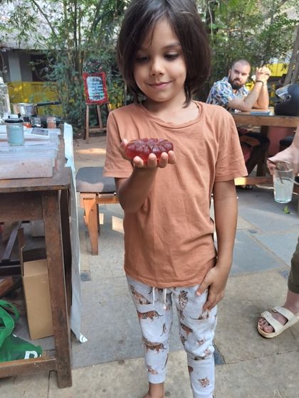 Here he is, admiring his finished creation. We used natural colorants to get this beautiful, rich red for his custom soap bar.