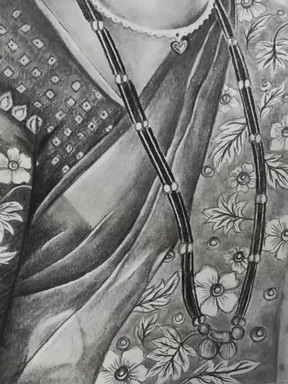 A detail shot focusing on the traditional mangalsutra necklace and the floral pattern of the sari, demonstrating my attention to intricate details in clothing.