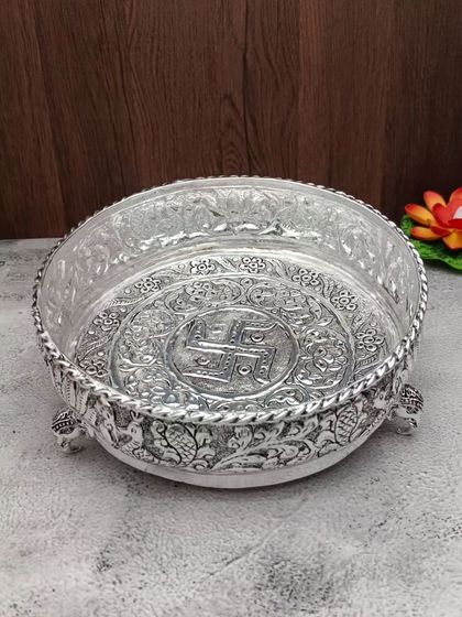 The same antique urli with elephant-leg stands, adding to its traditional charm.