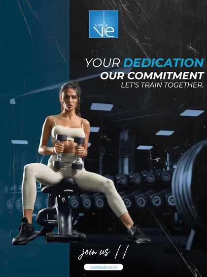 Your dedication is matched by our commitment. A member performs a dumbbell exercise in our well-stocked weight area, showing our promise to provide the tools and support for your fitness journey.