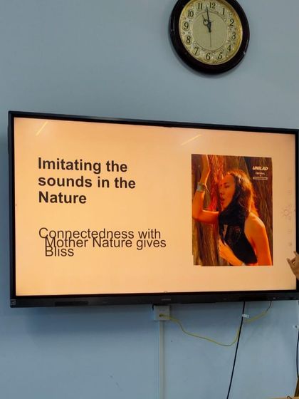 A photo from a lecture at the SVYASA Conference, where a presenter discusses the connection between nature and bliss.