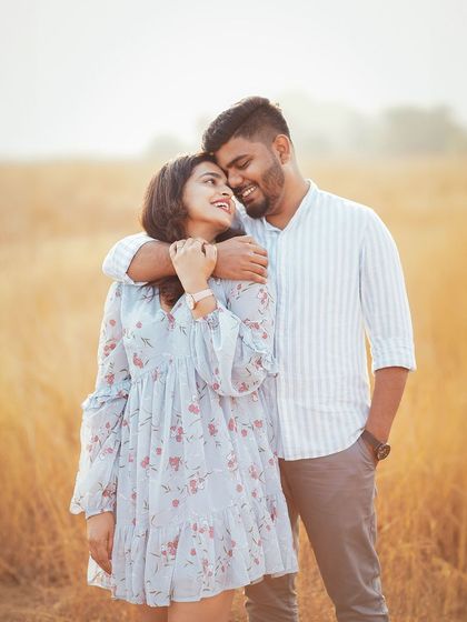 A happy, smiling portrait from the same golden hour field session. The warm light and natural setting create a beautiful, romantic atmosphere.