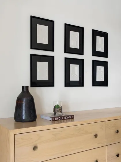A detail shot of the light oak dresser, showcasing the quality of the wood grain and the simple, elegant hardware.