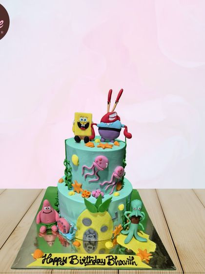 A detailed, two-tiered SpongeBob SquarePants cake featuring the whole gang. From SpongeBob and Patrick to Mr. Krabs and Squidward, all the beloved characters are here for the party.