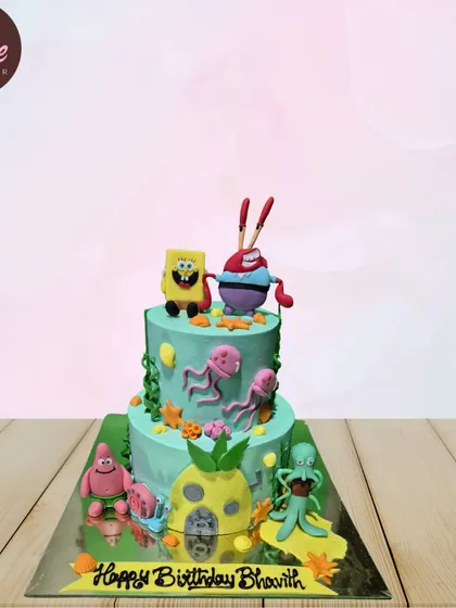 A two-tiered SpongeBob SquarePants cake featuring the whole gang. From SpongeBob and Patrick to Mr. Krabs and Squidward, all the Bikini Bottom favorites are here.