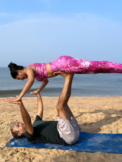 This pose, a variation of acro-yoga's "Front Bird," is where strength meets grace. The word yoga means union, and partner practice is a perfect expression of that, uniting two people in movement and breath.