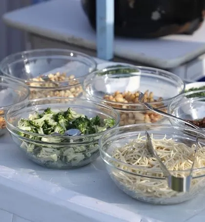Another view of the fresh ingredients at our live station, including noodles, broccoli, and nuts, ready to be cooked to order for guests.