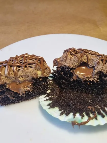 A cross-section of my center-filled Nutella cupcake. A rich chocolate cupcake is filled with a molten Nutella center and topped with fluffy frosting, creating an irresistible surprise in every bite.
