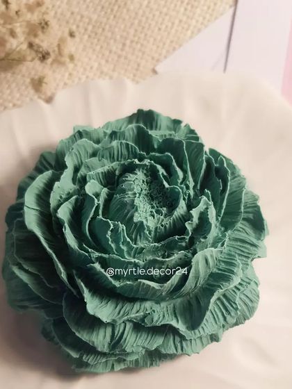 A close-up of the green Peony diffuser, showing the intricate detail of the petals. The porous Jesmonite material is perfect for diffusing scents slowly and consistently.