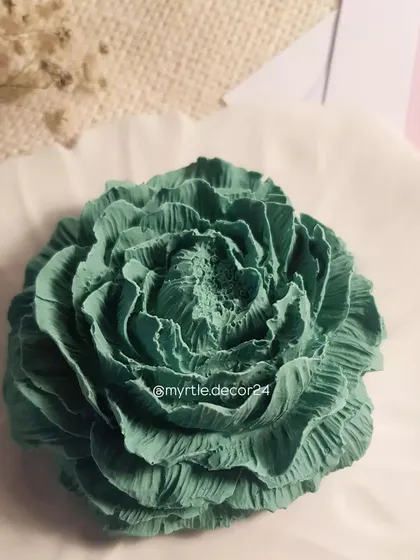 A close-up of the green Peony diffuser, showing the intricate detail of the petals. The porous Jesmonite material is perfect for diffusing scents slowly and consistently.